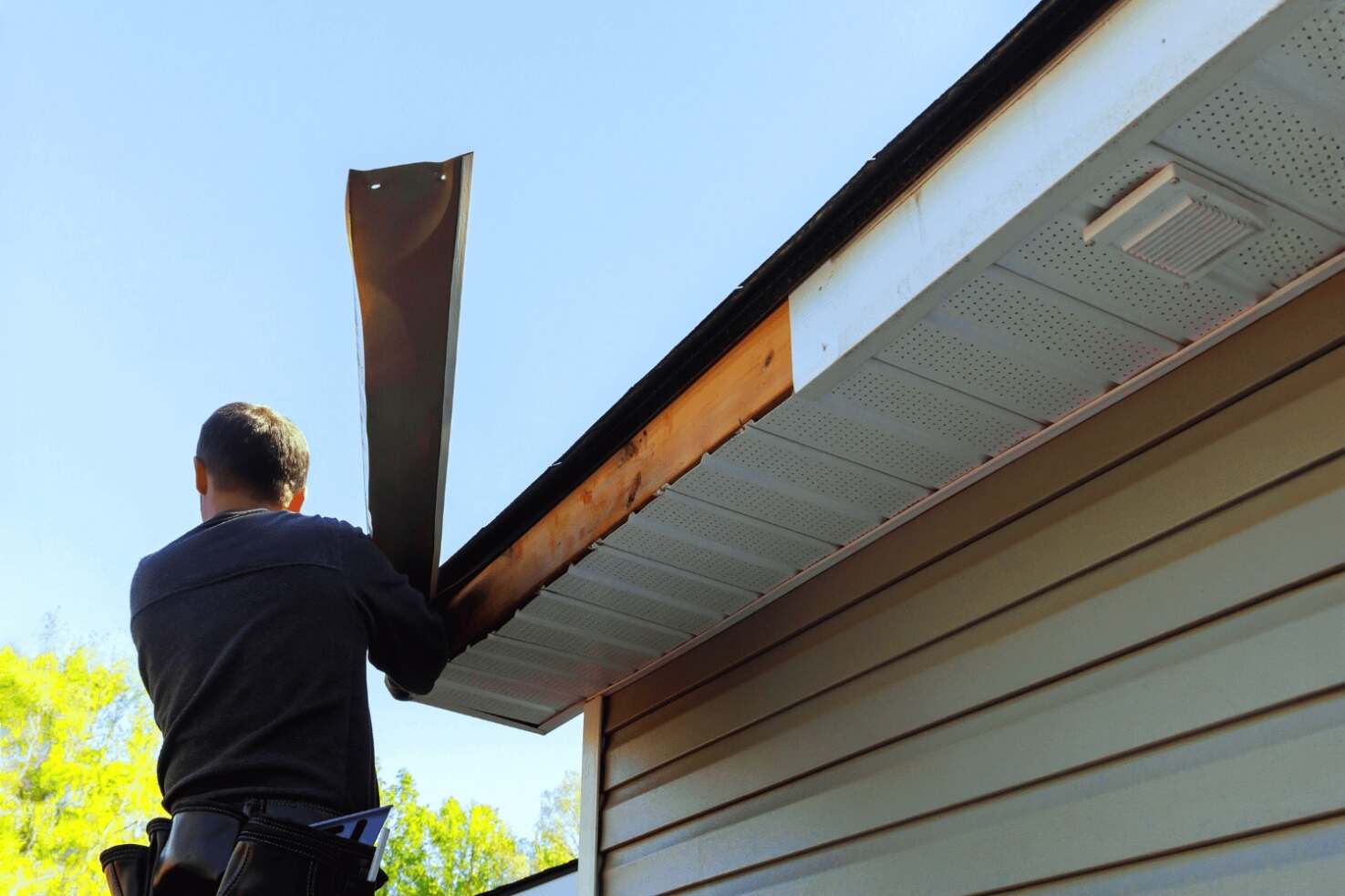 A photo demonstrating the steps to replace fascia boards on a house