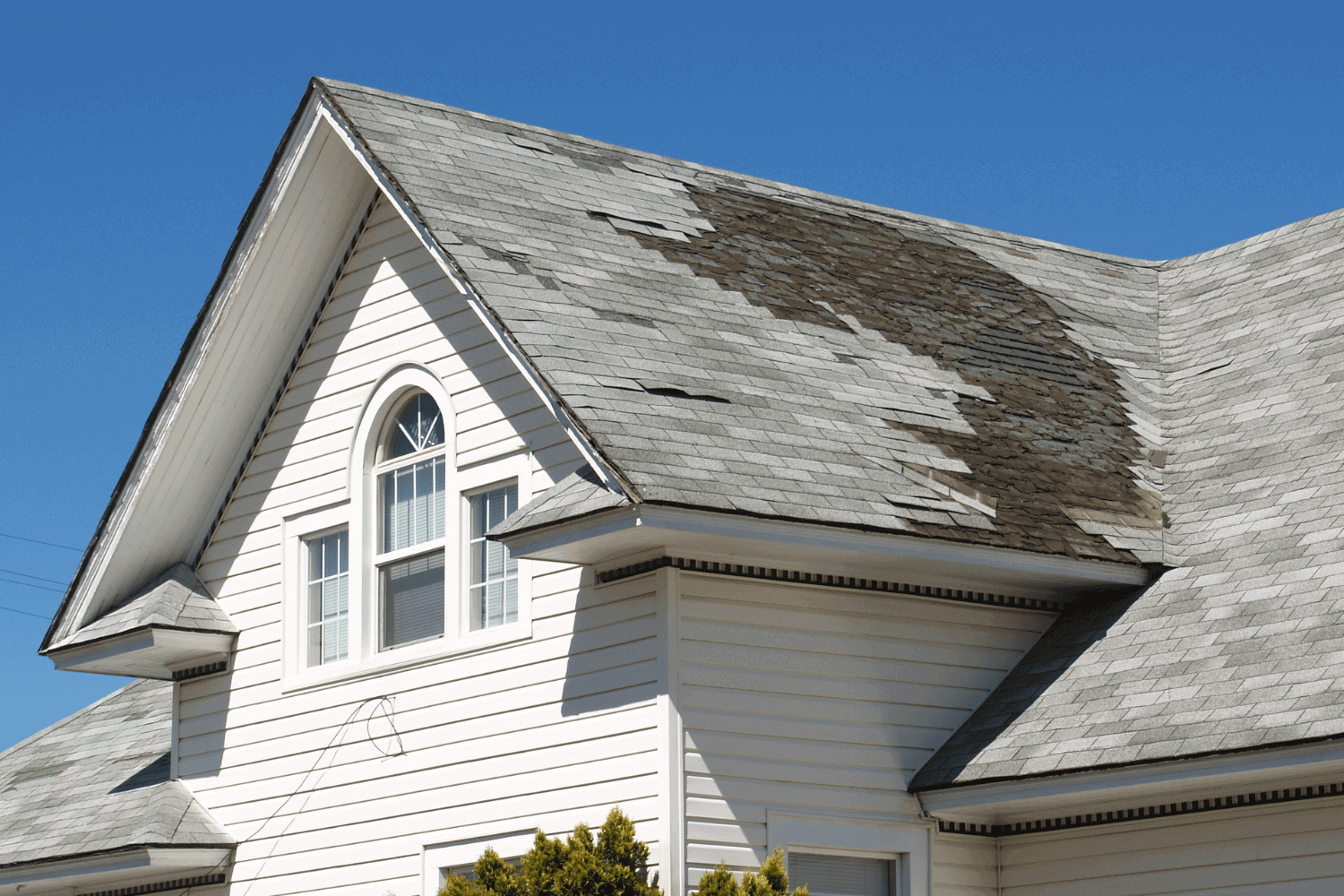 A photo showing a damaged roof with signs indicating it needs replacement