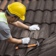 A photo of a homeowner preparing for roof replacement with tools and materials