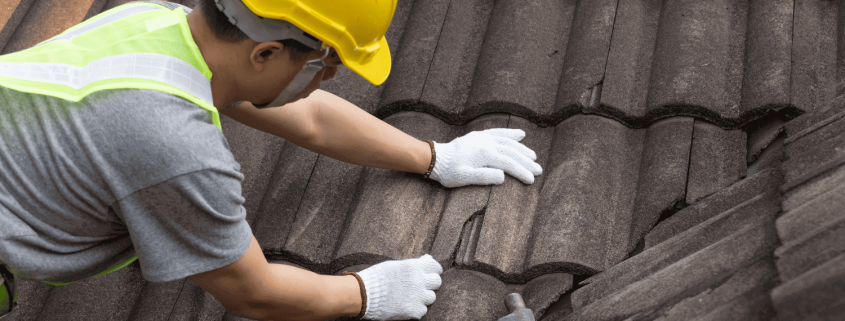 A photo of a homeowner preparing for roof replacement with tools and materials