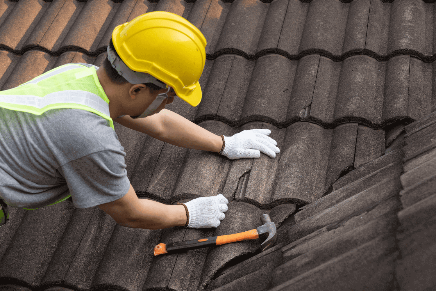 A photo of a homeowner preparing for roof replacement with tools and materials