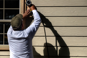 contractor installing siding