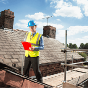 A professional roofer assessing a roof for potential shingle replacement