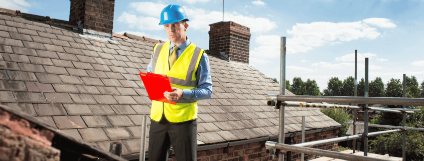 A professional roofer assessing a roof for potential shingle replacement