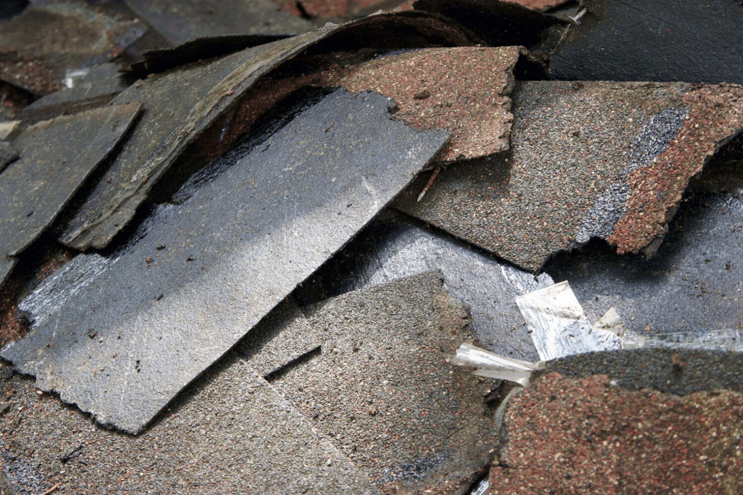 Cleaning up roofing debris after shingle removal, showcasing a clean work area