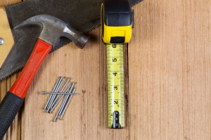 Hammer, Nails, And Tape Measure For Maintenance Of Cedar Shingles.