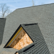 Ridge cap shingles being installed on a roof.