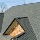 Ridge cap shingles being installed on a roof.