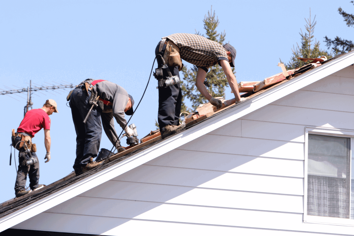 A professional inspecting roof flashing, ensuring proper installation and repair.