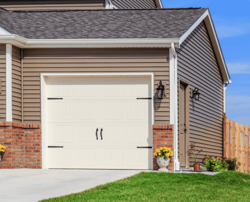 A comparative image showing vinyl siding next to wood and metal siding.