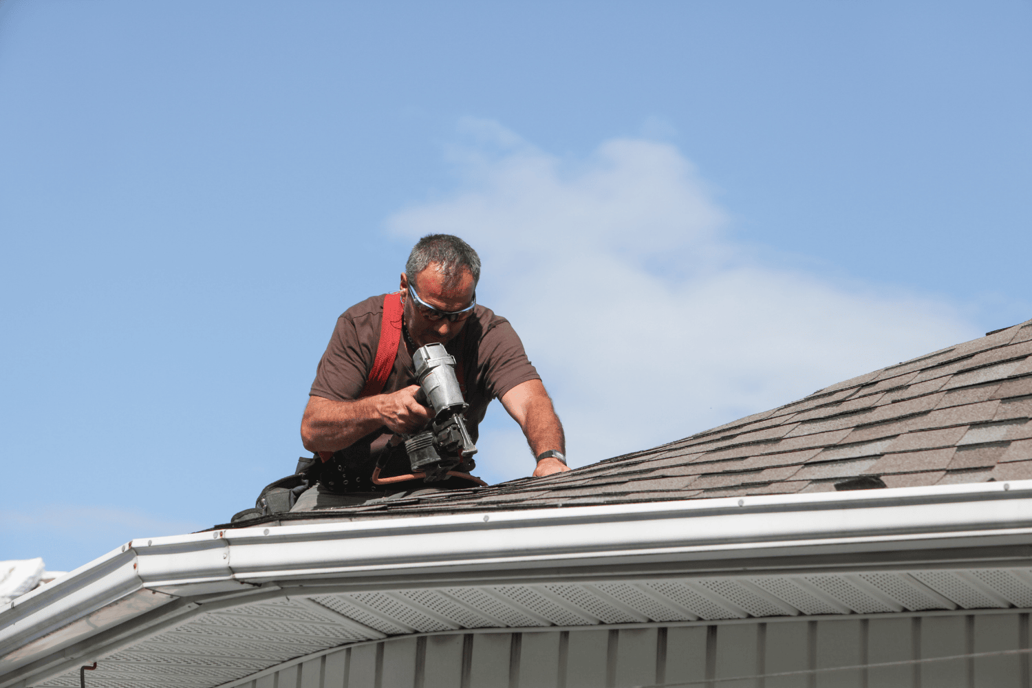 A professional roofer conducting a regular roof inspection.