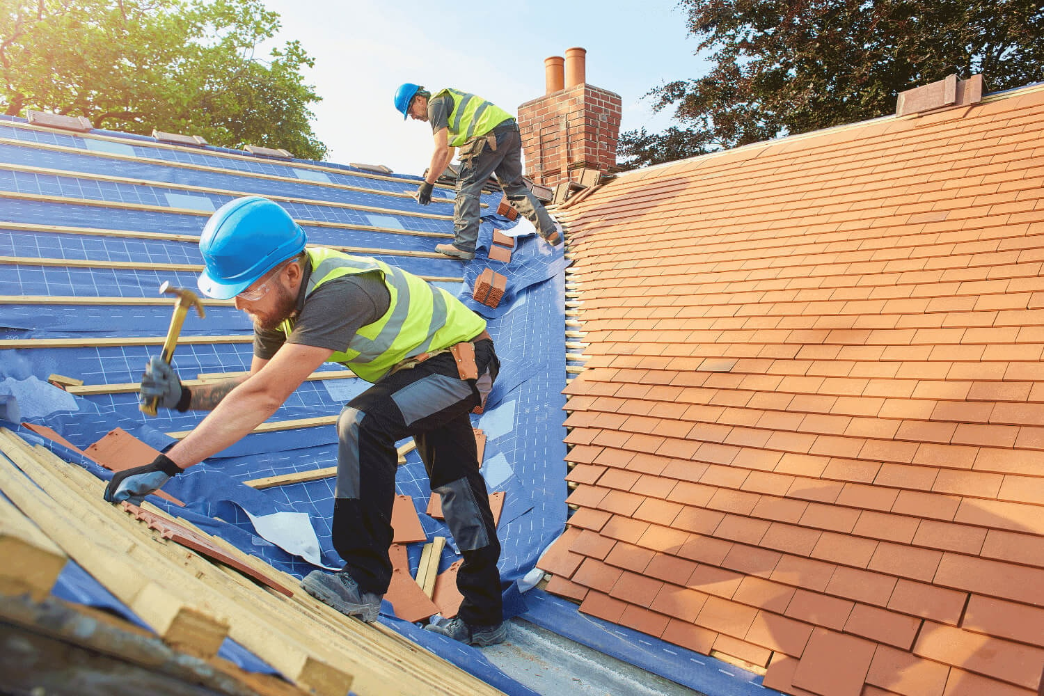 Underlayment and starter shingles being laid on a roof.