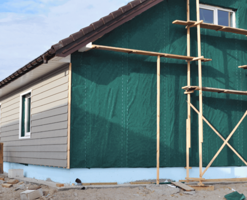 Preparing the home's exterior for vinyl siding installation.