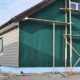 Preparing the home's exterior for vinyl siding installation.