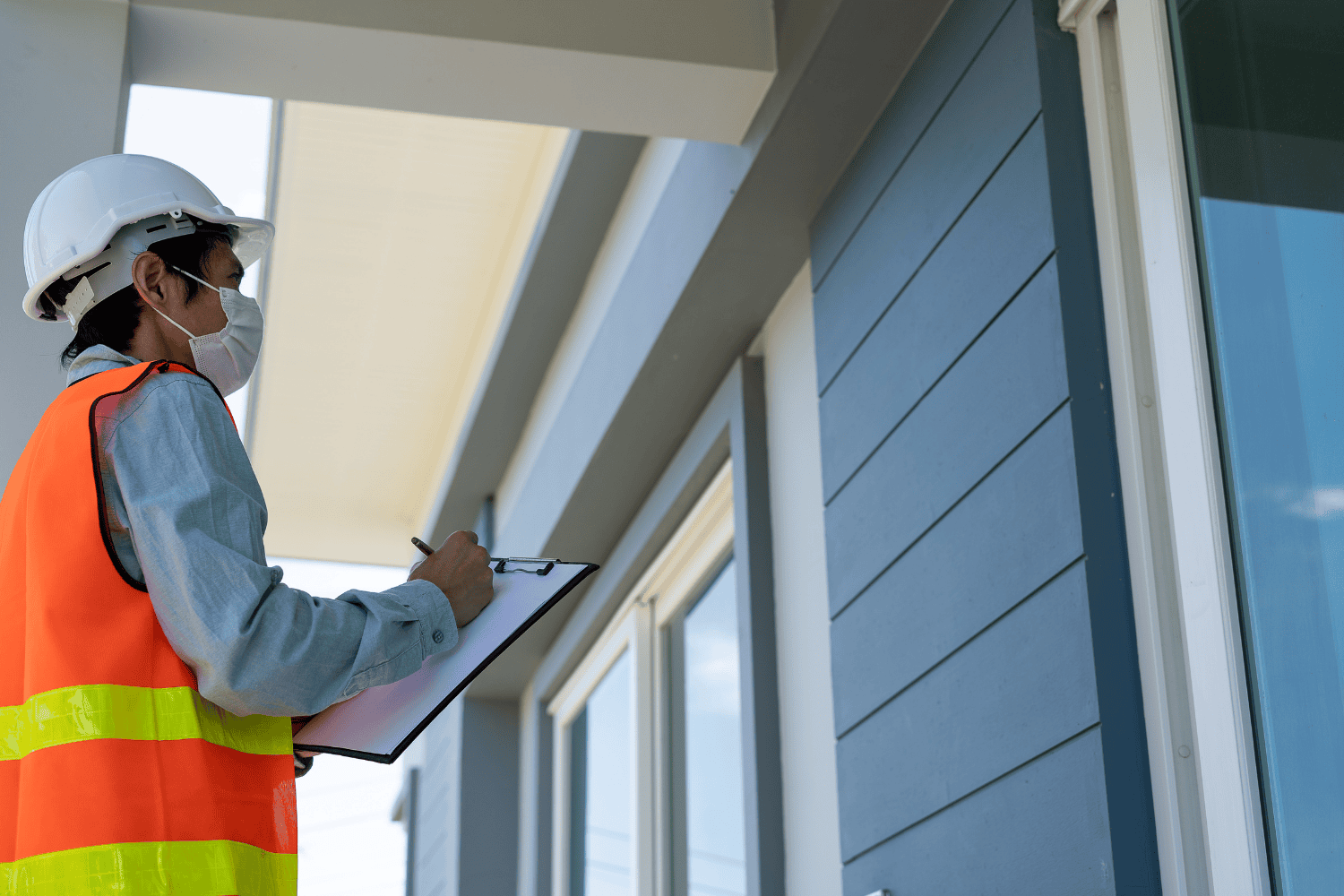 A person inspecting a roof for leaks, looking for signs of roof damage.