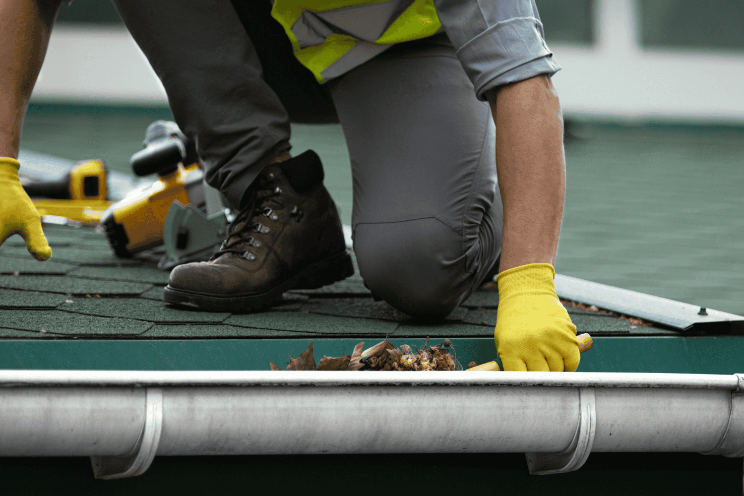 A detailed view of a gutter system being installed.