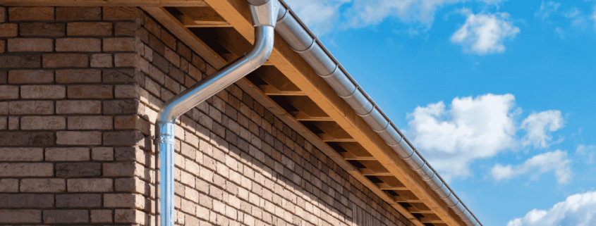 An image showing the installation process of a downspout cleanout.