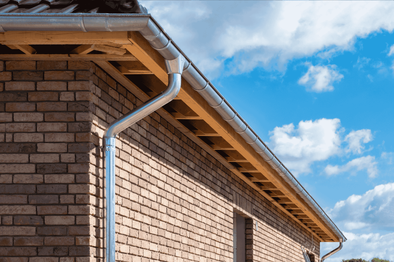 An image showing the installation process of a downspout cleanout.