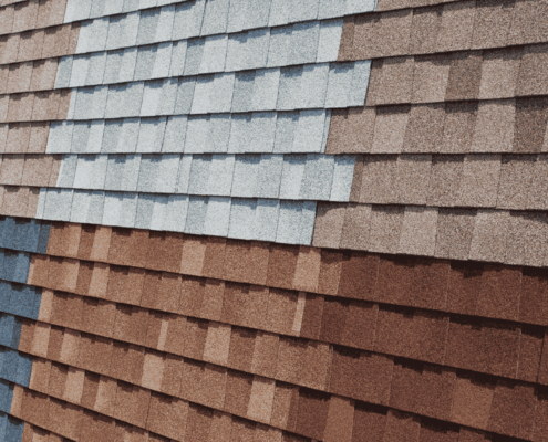 A variety of asphalt shingles displayed in different colors and styles, showcasing the popular choice for roofing.