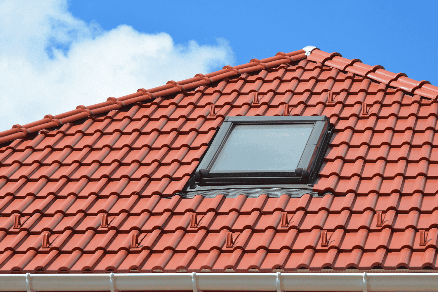 Clay tile roofing on a beautiful house, representing timeless elegance.