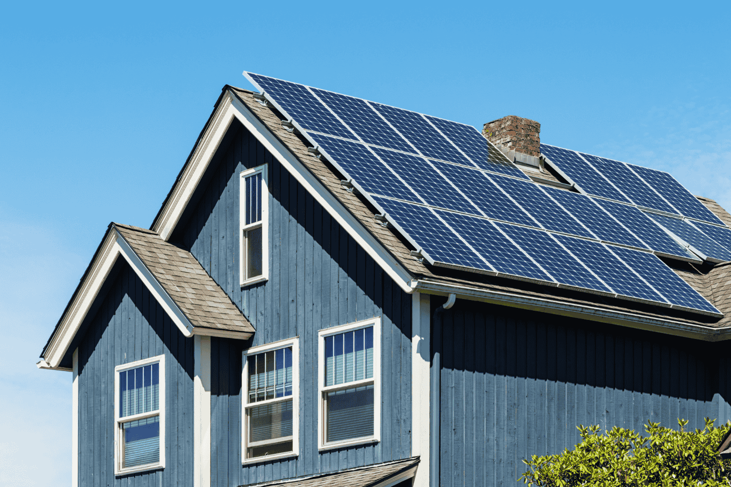 Solar shingles integrated into a roof, demonstrating energy efficiency.